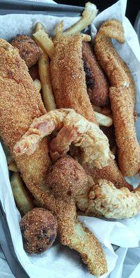 Combo: shrimp, fish, crab cakes with sides: fries & hush puppies. They didn't have some of the side selections listed on the menu.