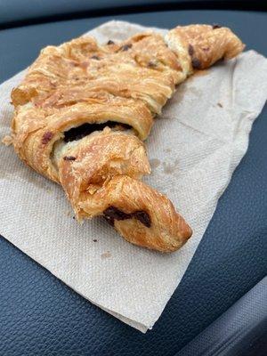 Soggy croissant which has a moldy flavor, reheated in a microwave instead of a commercial toaster.