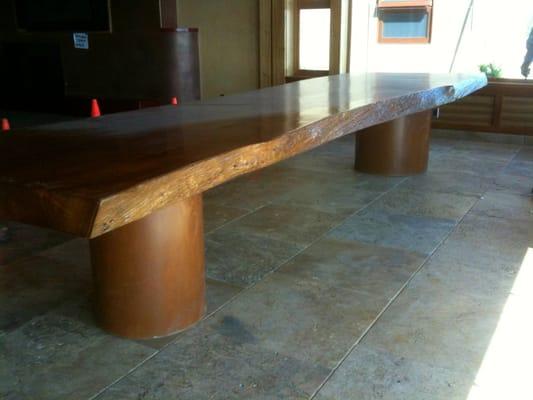 Wood slab table with custom concrete base