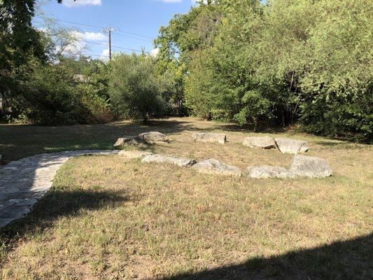 Out yonder around back... rock seating circle