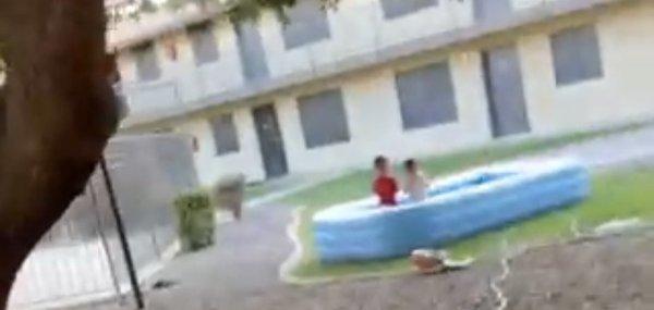 Two minor children in a pool outside with no parental supervision