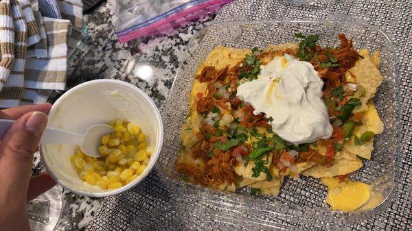 Elote (halfway eaten, there was crema and cheese on top I promise) and brisket nachos (jalapeños not pictured)