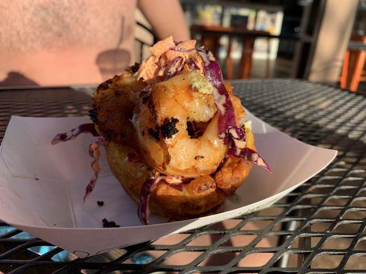 Patacon bite (fried plantain bite) with camarones (shrimp) filling and slaw