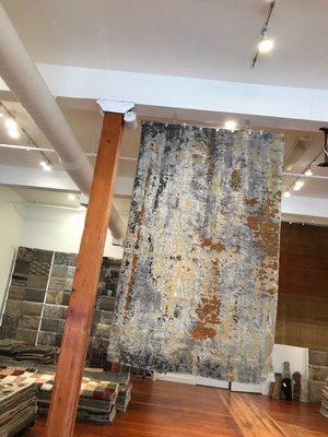 A Basalt Fire rug, hand knotted in wool and silk. Hanging at our gallery in Portland Oregon.