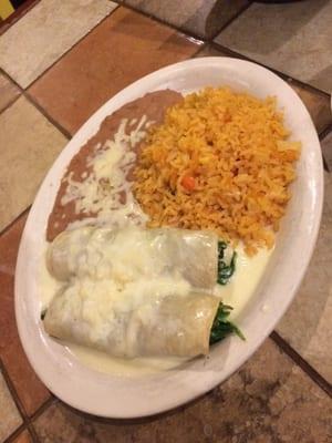 Vegetarian dish - spinach & cheese enchiladas with rice and beans.