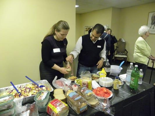 Volunteers making sandwiches for senior housing residents.