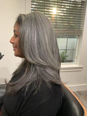 Layers and Textured Haircut to remove weight from this natural silver beauty followed by a humidity resistant blowout.