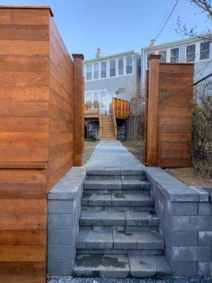 Gorgeous stained  cedar horizontal fence & gate. This project was constructed around a newly installed Nicolock retaining wall & staircase.