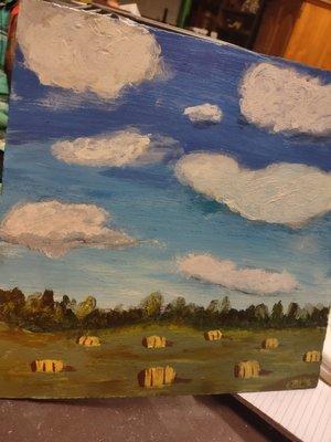 Fluffy clouds and bales of hay by Catherine Borges