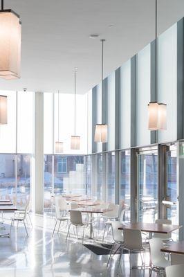 Inside cafe seating area looking out at reflecting pool.