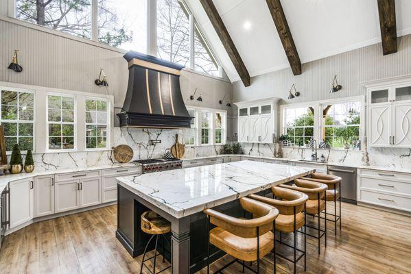 Paonazzo Marble kitchen countertops with large island and full backsplash.