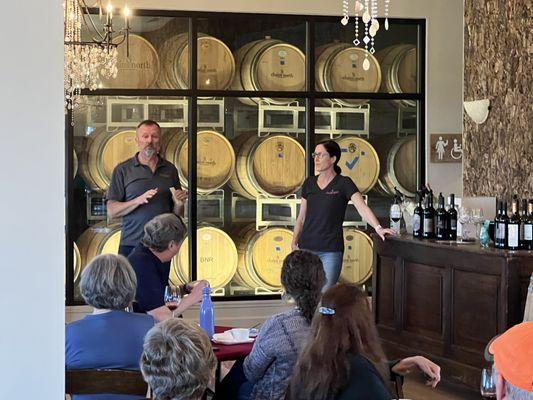 The owners in the Compass Rose Room with lit barrels in the Production Room.