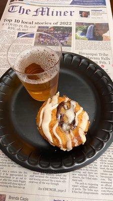 Apple juice and one of their delicious cinnamon buns with their daily newspaper!