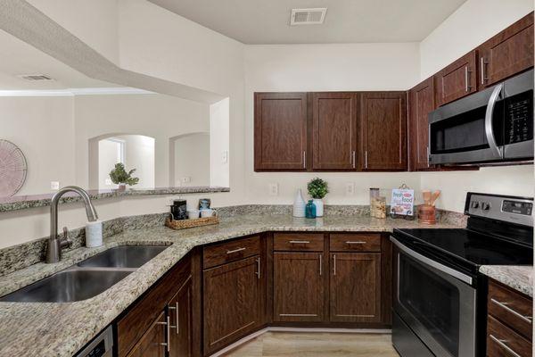 Kitchen with stainless steel appliances at The Estates of Northwoods