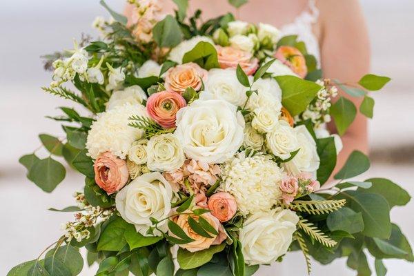 Peace and white roses, ranunculus, stock, football mums make a gorgeous bouquet