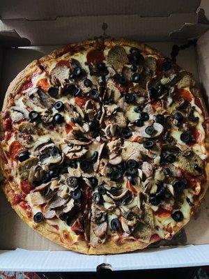 Meat Lovers Pizza with olives and mushrooms.