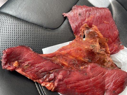 Fatty Beef Jerky.  You can see the off color orange that is smoked fat!  Poor choice not to cut the fat off before selling it.