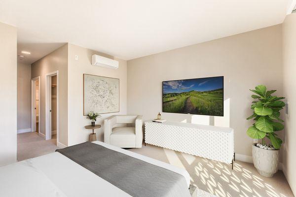 Bedroom with ample sunlight, large closet, and en suite bathroom.