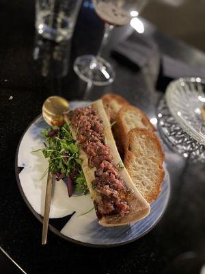 Bone Marrow topped with A5 Wagyu tartare, served with Acme ciabatta