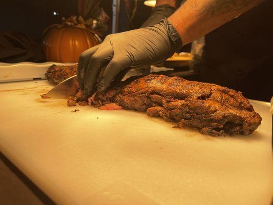 Chef Attendee Slicing Fresh Tenderloin of Beef at Carving Station