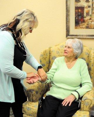 Caregiver checking the pulse of a senior patient