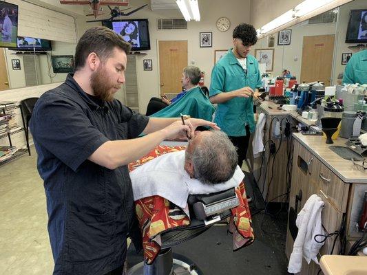 Cris finishing a beard trim with the straight razor.