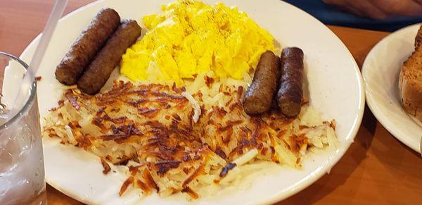 Scrambled eggs, hash browns, breakfast sausage.