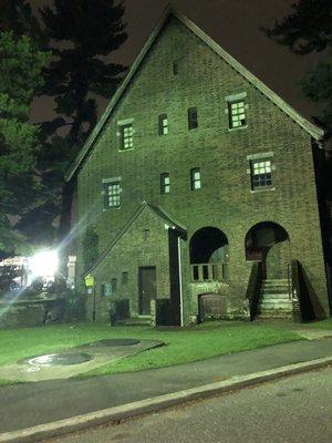 House on property bathed in green light of the night