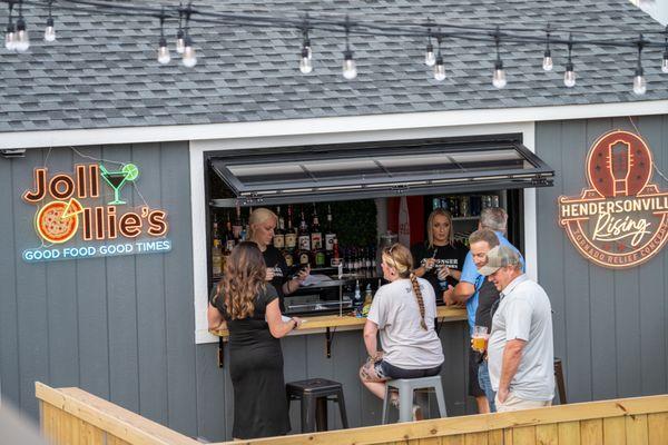 Customers enjoying a drink at the outdoor bar at Jolly Ollie's Pizza and Pub in Hendersonville, TN