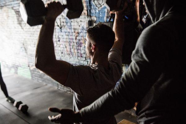 Owner/Trainer John performing a seated shoulder press