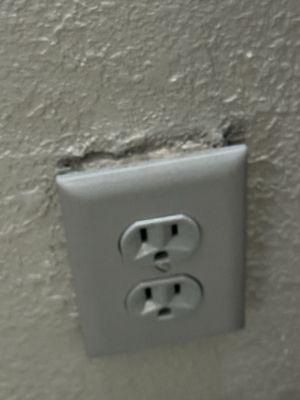 Outlet coming off wall with putty behind it.