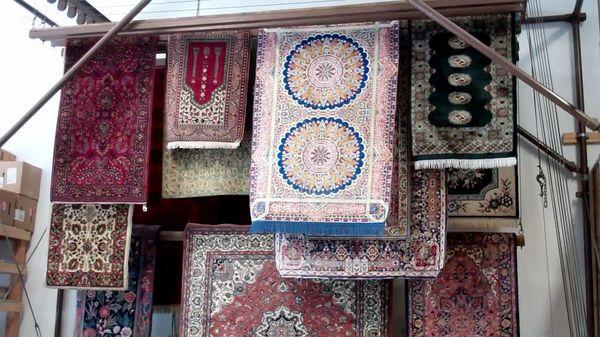 An assortment of fine wool and silk rugs.