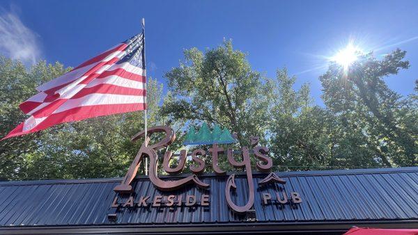 Old glory waving in the sunlight outside of Rusty's.