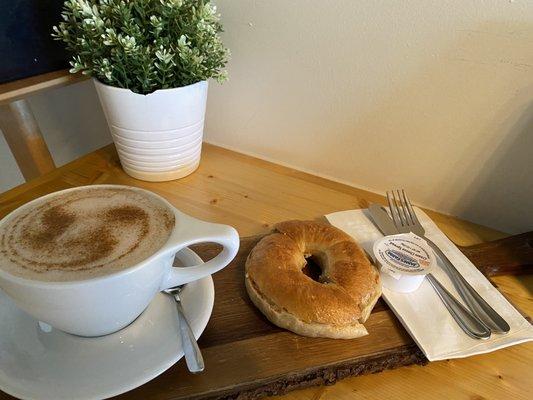 Hot Chai Tea Latte with almond milk, Warm Plain bagel with cream cheese.