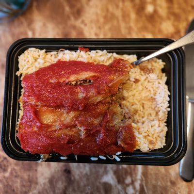 Mouthwatering stuffed eggplant over a generous serving of rice.