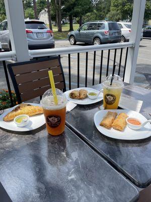 Yellow Curry chicken puff, veggie samosas, veggie spring rolls,  tropic ginger twister, mango -passionfruit tea