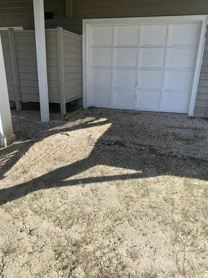 This is a photo of the backyard the rock is in bad shape with the black underlayment coming through