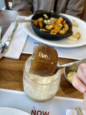 Big coffee ice cube in the pumpkin cold brew