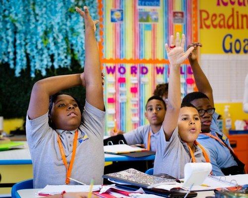 Great Oaks Charter School Students Hands Raised in Class