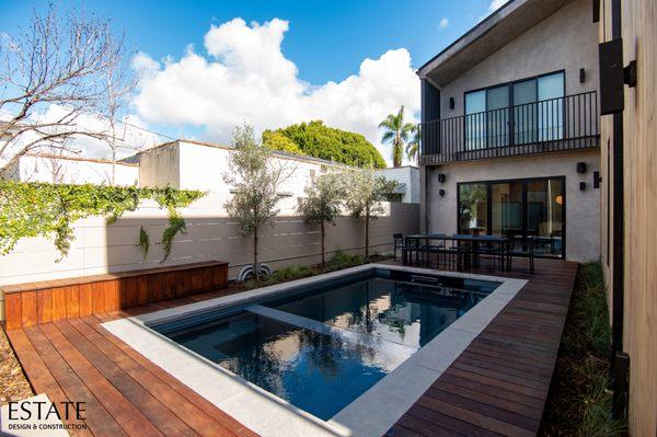 New deck, poolside storage, and hardscaping elements