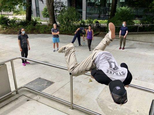 Coach Payton demonstrates a gate vault in the Parkour Fundamentals adult class.