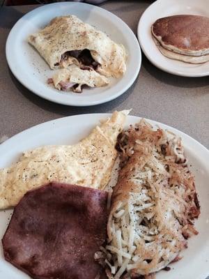 3 meat and cheese omelette and a 2 egg choice of meat with hash browns and pancakes very yummy