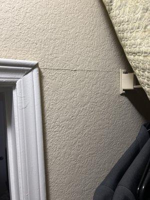 Crack along closet wall. Makes the door very difficult to open and close.