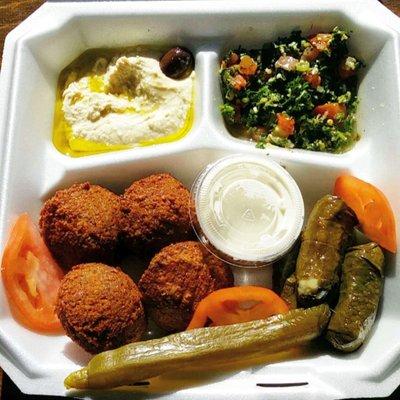 Vegetarian falafel plate: hummus, tabouli, falafel and dipping sauce, vegetarian grape leaves (baba ghanouj and pita not shown).