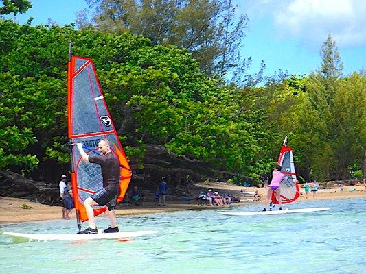 Dad and daughter windsurfing