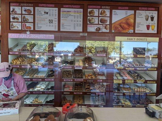 Large variety of donuts, even in the early evening when this photo was taken.