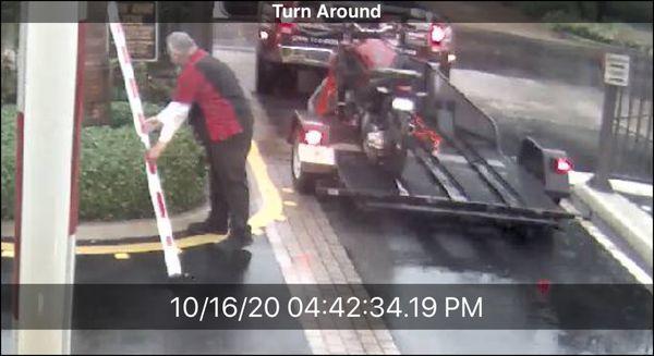 JM Hond Miami Delivery Driver tossing broken gate arm into the bushes.