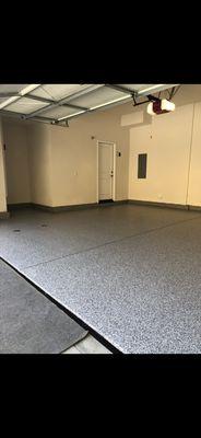 After pic to a 2 car garage with an epoxy floor coating.