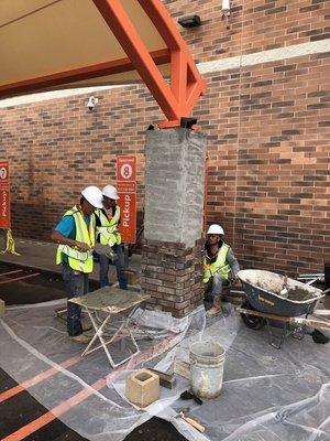 Bonding the thin cut brick veneer to the scratch coat using a polymer mortar.