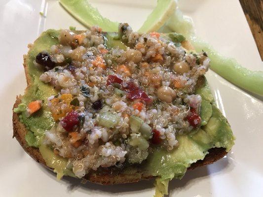 Sourdough avocado toast topped with quinoa salad